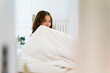 © Nuria Seguí/Stocksy - Smiling Female Covering Face With Blanket
