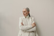 © Sergey Filimonov/Stocksy - Elegant senior woman with gray hair portrait in studio