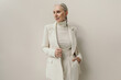 © Sergey Filimonov/Stocksy - Successful senior woman portrait in white blazer