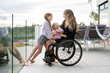 © Santi Nuñez/Stocksy - Portrait of mother in wheelchair with her daughters