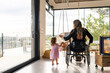 © Santi Nuñez/Stocksy - Mother in wheelchair enjoying with her daughter