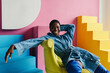 © Sergey Filimonov/Stocksy - Happy black woman portrait in colorful interior