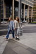 © Tatiana Timofeeva/Stocksy - two female sisters walk around the city and laugh