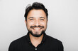 © Shikhar Bhattarai/Stocksy - Smiling South Asian Man against a white background.