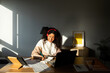 © Valentina Barreto/Stocksy - Hispanic woman working in office