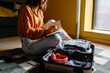 © Alba Vitta/Stocksy - Woman preparing travel suitcase
