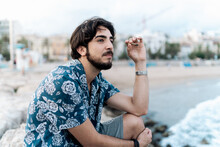 Young Man Smoking Marihuana At The Beach