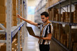 © Raymond Forbes Photography/Stocksy - Hispanic man with laptop computer checking inventory