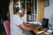 © Santi Nuñez/Stocksy - Pensioner man using laptop