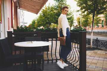 Wall Mural - short haired woman on the street vacation in the city summer education