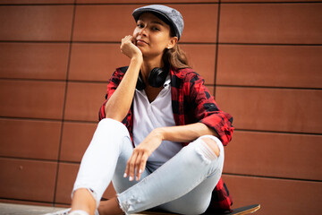 Wall Mural - Fashion urban woman with skateboard. Young happy girl enjoy outside.