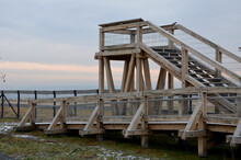 Platform Of A Lookout Tower Made Of Oak Logs And Planks With Barrier-free Access For Seniors And The Immobile. Wheelchair Ramp. Metal Railings Of Stainless Steel Polished Tube