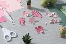 Multi-colored Paper Crafts On The Cutting Mat And Scrapbooking Tools, Top View