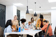 © Santi Nuñez/Stocksy - Young people working in the office