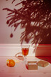 © Sergey Narevskih/Stocksy - Orange and champagne near shadow of Christmas tree