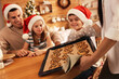 © New Africa - Happy mother giving her family freshly baked delicious Christmas cookies at home, closeup