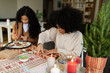 © Valentina Barreto/Stocksy - Christmas activities with friends at home