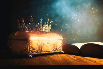 Sticker - low key image of beautiful queen or king crown and old book. vintage filtered. fantasy medieval period