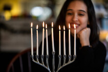 Hanukkah: Teen Girl Gazes At Menorah And Candles