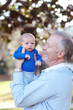 © Dina Marie Giangregorio/Stocksy - Grandpa Holding Newborn Boy