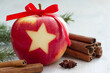 Christmas background, apple with star cut out and spices 