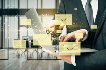 Poster - Close up of businessmen hands pointing at laptop with creative glowing letters interface on blurry office interior background. E-mail networking, teamwork and correspondence concept.