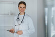 © Westend61 - Mid adult female doctor standing with digital tablet