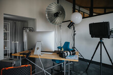 Empty Studio With Photography Equipment At Desk