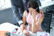 © H_Ko - Businessman hugs embarrassed employee in office closeup