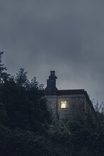 A Ruined House With A Light At The Window