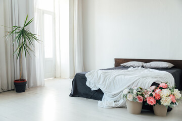 Poster - interior of a white bedroom with bed and flowers with window