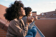 © Santi Nuñez/Stocksy - Young women enjoying on a balcony.