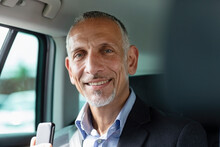 Smiling Male Professional Sitting In Car