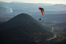 Colourful Wing Flies Over Rounded Mountains