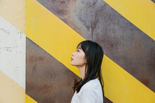 Portrait Of Girl In Front Of A Wall With Yellow Lines