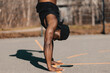 © Westend61 - Man doing handstand over mobile phone on sports court