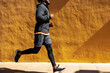 © BONNINSTUDIO/Stocksy - Crop black man running on street