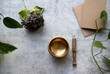 © Lauren Lee/Stocksy - Meditation bowl and plants