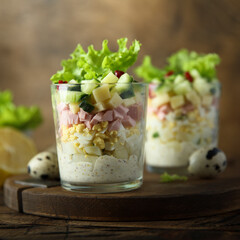 Wall Mural - Green salad with ham and cheese served in a glass