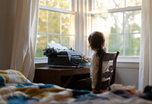 Little Girl Typing And Being Creative On Typewriter