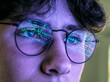 © Westend61 - Teenage boy with graph reflection on eyeglasses