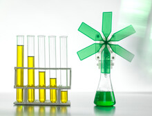 Oil In Test Tubes By Beaker With Green Turbine On Table