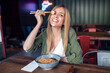 © nenetus - Funny beautiful woman eating ramen with chopsticks in asian restaurant.