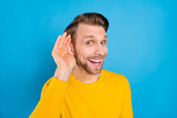 Sticker - Photo portrait of man listening rumor keeping hand near ear isolated on vibrant blue color background