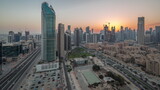 Fototapeta Na sufit - Dubai's business bay towers aerial day to night timelapse. Rooftop view of some skyscrapers