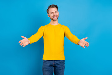 Poster - Photo of young guy happy positive smile open arms hug cuddle friendly invite isolated over blue color background