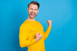 © deagreez - Profile side photo of young guy happy positive smile celebrate victory win lottery fists hands isolated over blue color background