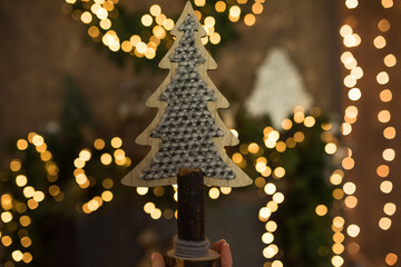 Wall Mural - Christmas tree made from natural materials against a background of yellow lights, Christmas wooden tree.