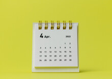 Desktop Calendar For April 2022 On A Yellow Background.