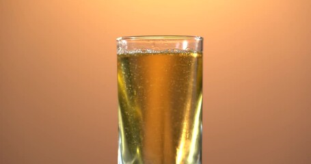 Wall Mural - Healthy apple juice pour in a rotating glass. Juice splash. Colour background. Closeup footage for advert